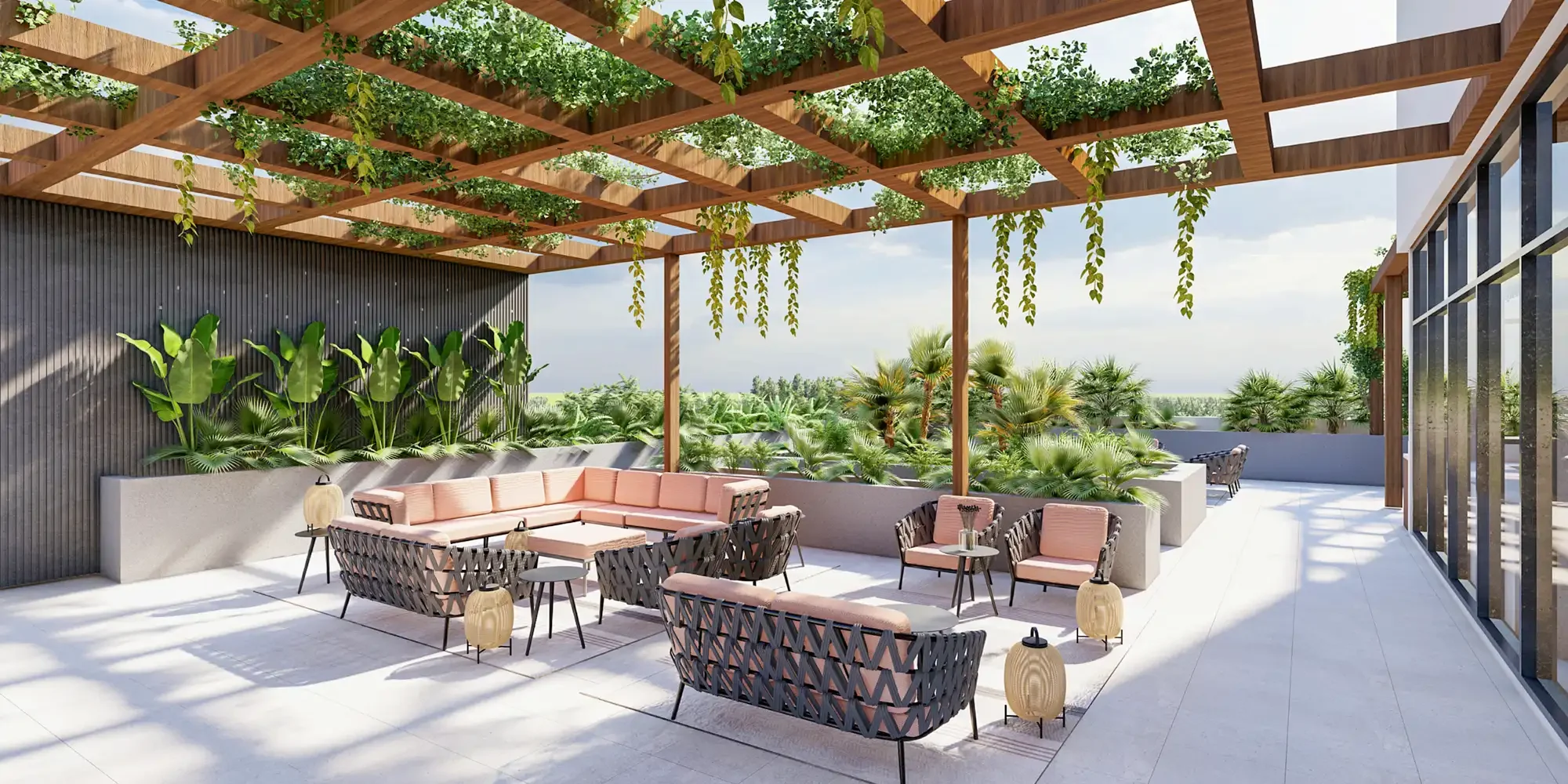 Outdoor Roof Terrace of the GNPC office design. The roof terrace consists of lounge chair and lounge sofas in grey rope structure and light pink cushions. Along with lounge furniture there are wicker lanterns also placed in the floor